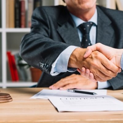 lawyer-his-client-shaking-hands-together-desk_23-2147898427